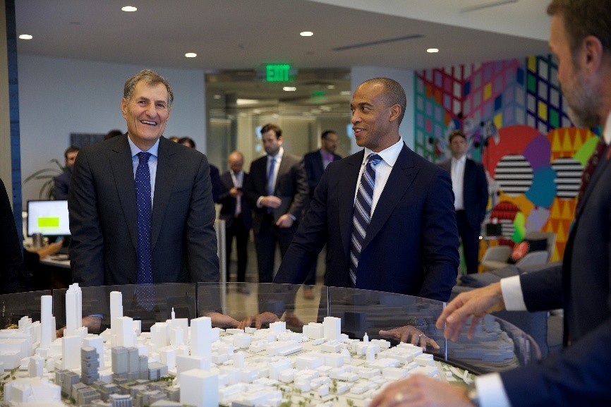 Project leaders show Secretary Turner a model of the long-term plan for the Centennial Yards development.