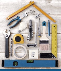 A collection of tools aligned to shape a silhouette of a house.